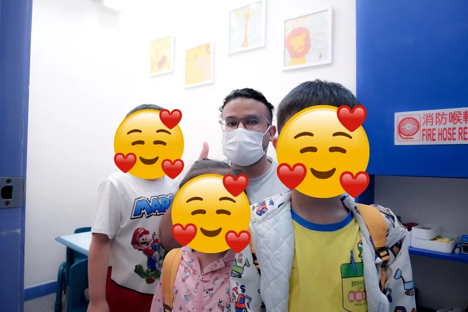 Mr. Nas with a group of young learners in the classroom